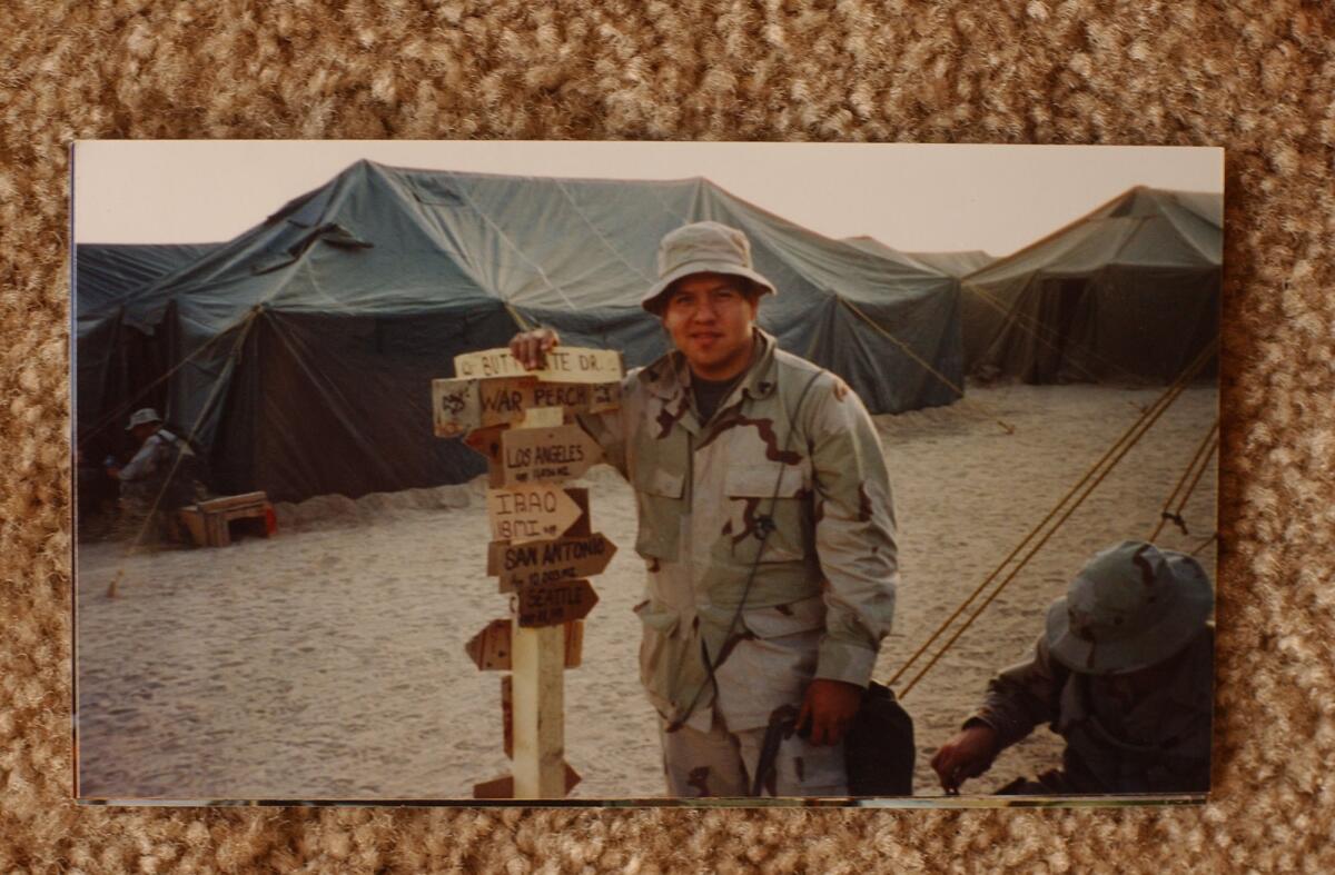 Cpl. Jose Garibay at a signpost in Kuwait, near the Iraqi border. (Toshia Hooven / Mark Courtney/For The Times)