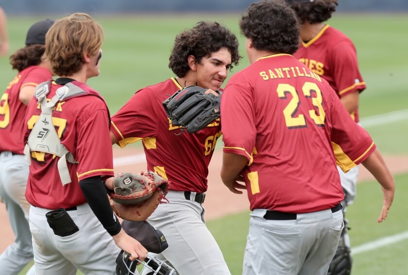 Estancia's James De La O, center, is congratulated after closing out the 10th inning against Anaheim on Saturday.