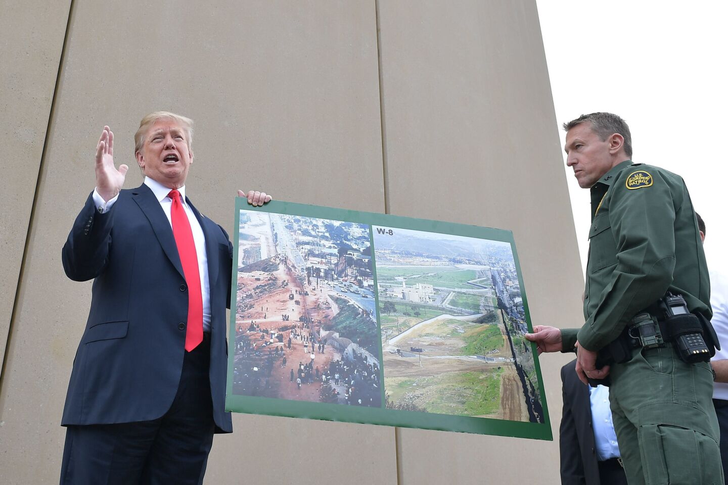 President Trump with a photo of the San Diego border area from the 90s and now.