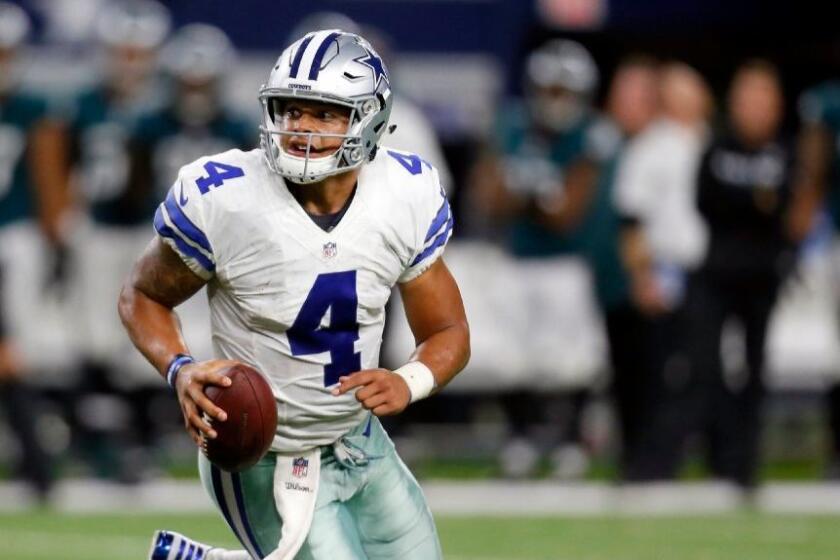 Cowboys quarterback Dak Prescott scrambles out of the pocket during a game against the Eagles on Oct. 30.