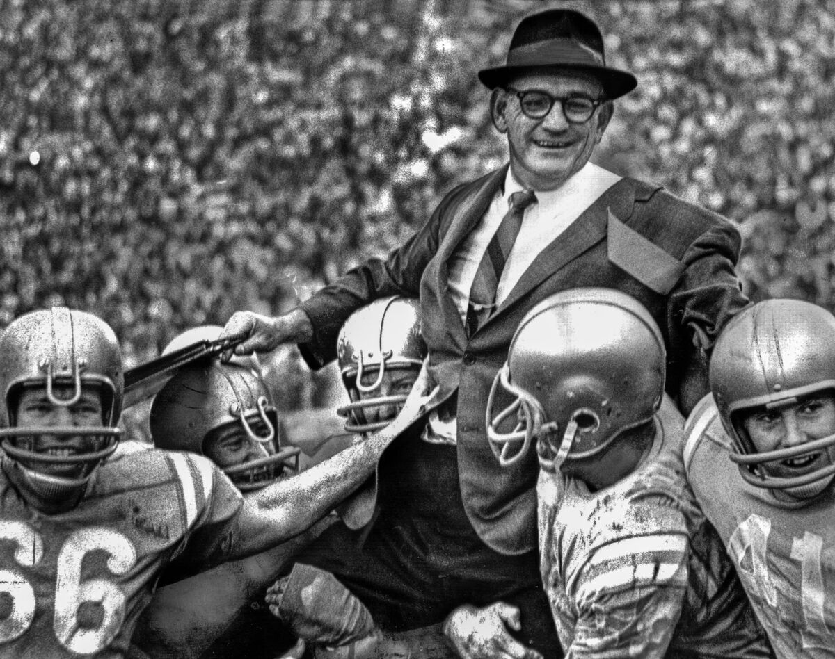 Jan. 1, 1966: UCLA coach Tommy Prothro is hoisted up after the fifth-ranked Bruins beat the Spartans, the No. 1 football team in the nation.