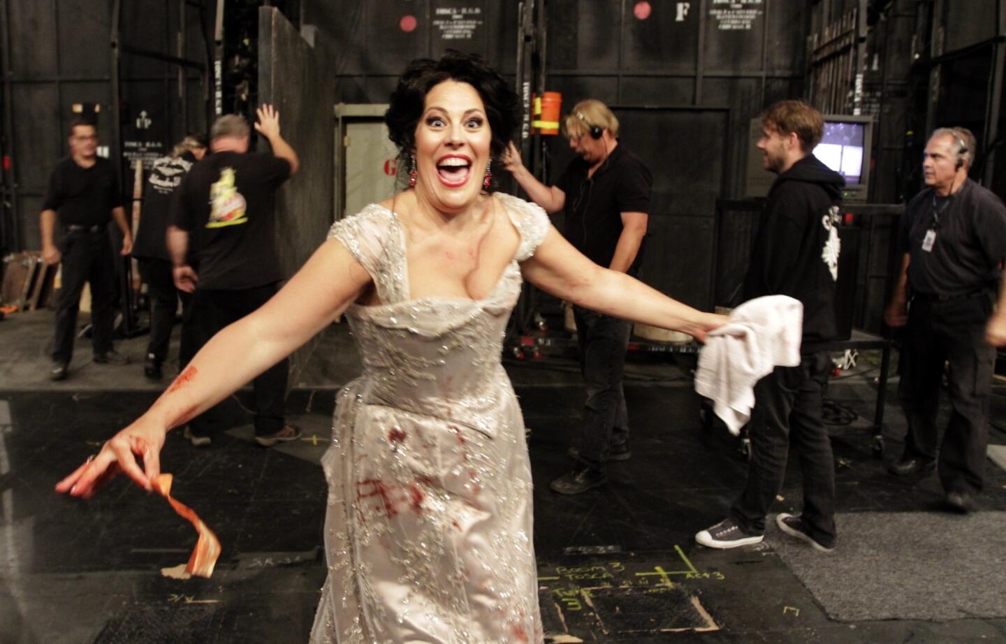 Soprano Sondra Radvanovsky, singing the role of Tosca, coming off stage after a gory scene in the L.A. Opera's performance of "Tosca."