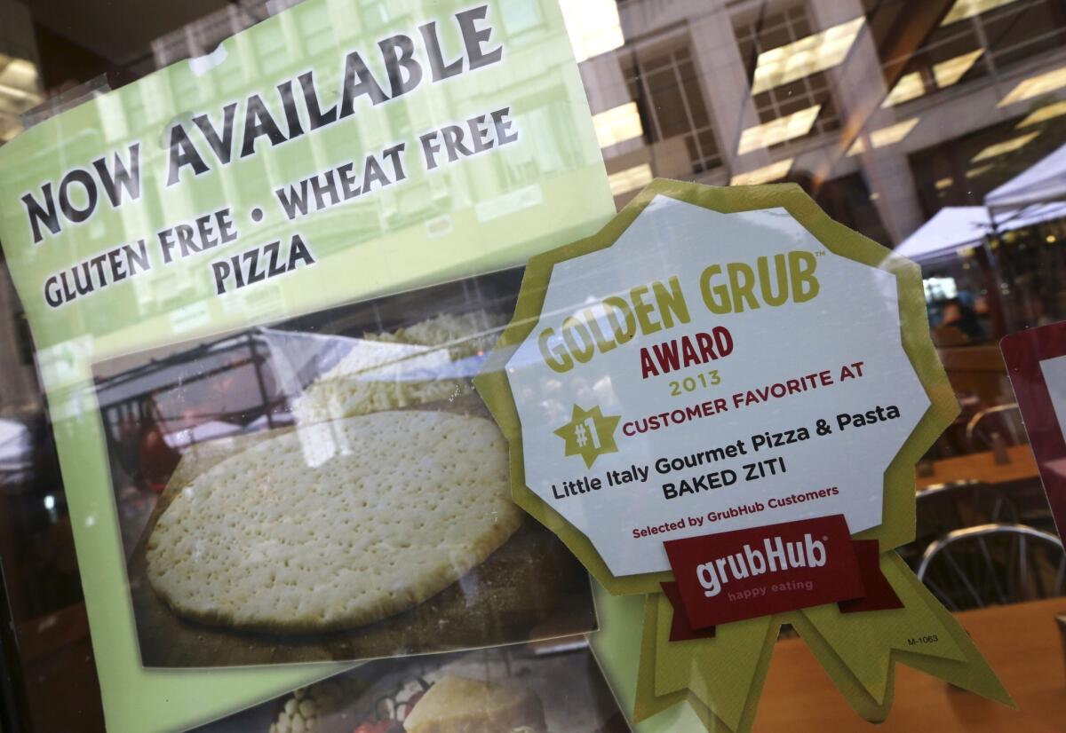 GrubHub, an online food ordering company, on Monday set an initial public offering price range of $20 to $22 a share. Above, a GrubHub sticker is displayed in the window of a New York restaurant.