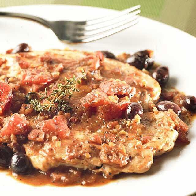 Basque-style chicken with pancetta, nicoise olives, and thyme sprigs.