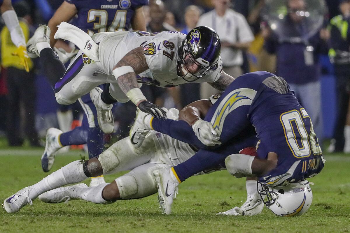 Chargers punt returner Desond King is toppled after 24-yard return late in the game against the Baltimore Ravens at StubHub Center on Saturday.
