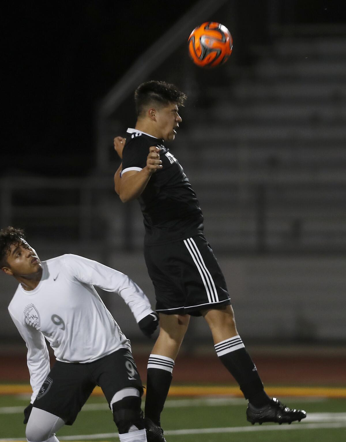 Estancia's Chris Ayala, right, heads the ball while Century's Freddy Navarro watches during the first half of a nonleague match on Wednesday.
