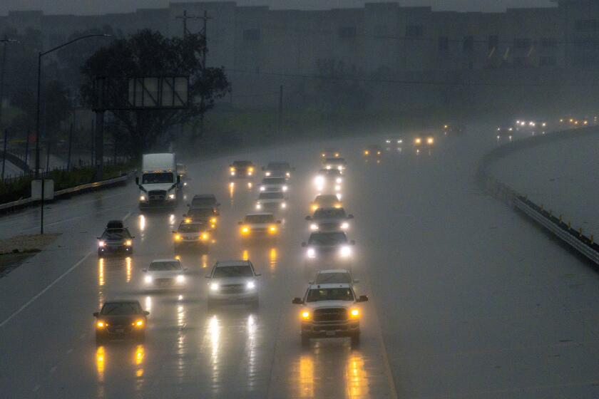 Fontana, CA - January 14: Drivers keep distance and drive carefully in pouring rain on Freeway 15 on Saturday, Jan. 14, 2023 in Fontana, CA. (Irfan Khan / Los Angeles Times)