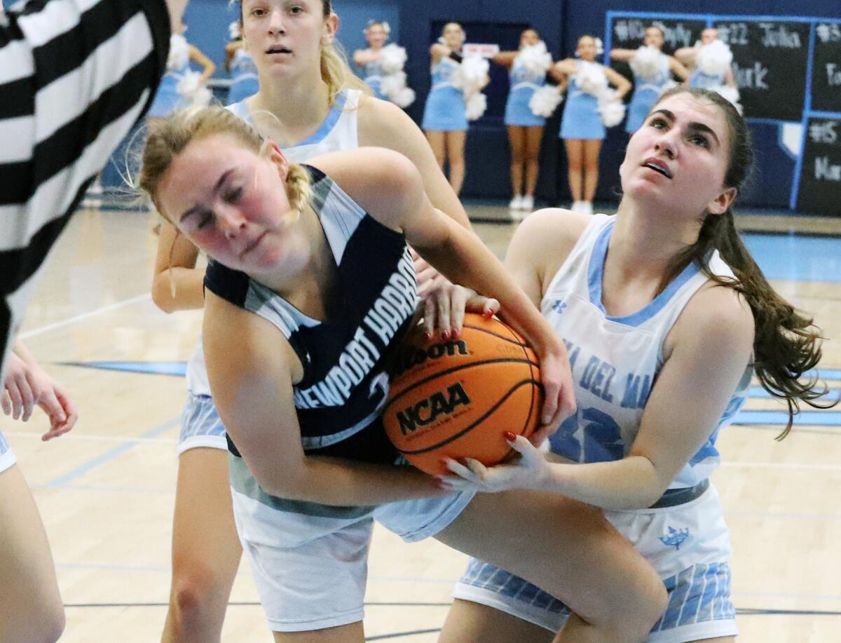 Newport Harbor's Gianna Briggs (2) and Corona del Mar's Julia Mork (22) fight for a loose ball in the Battle of the Bay.