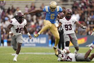 UCLA quarterback Justyn Martin, second from left, escapes a tackle by North Carolina Central defensive back Kole Jones, lower right, as linebacker Jaki Brevard, left, and defensive lineman Dylan Hall chase during the second half of an NCAA college football game Saturday, Sept. 16, 2023, in Pasadena, Calif. (AP Photo/Mark J. Terrill)