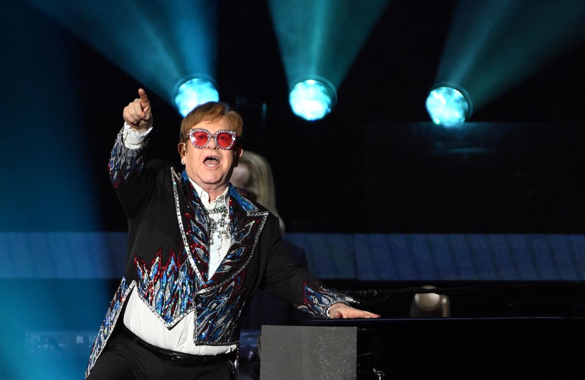 Elton John points to the crowd at Dodger Stadium.