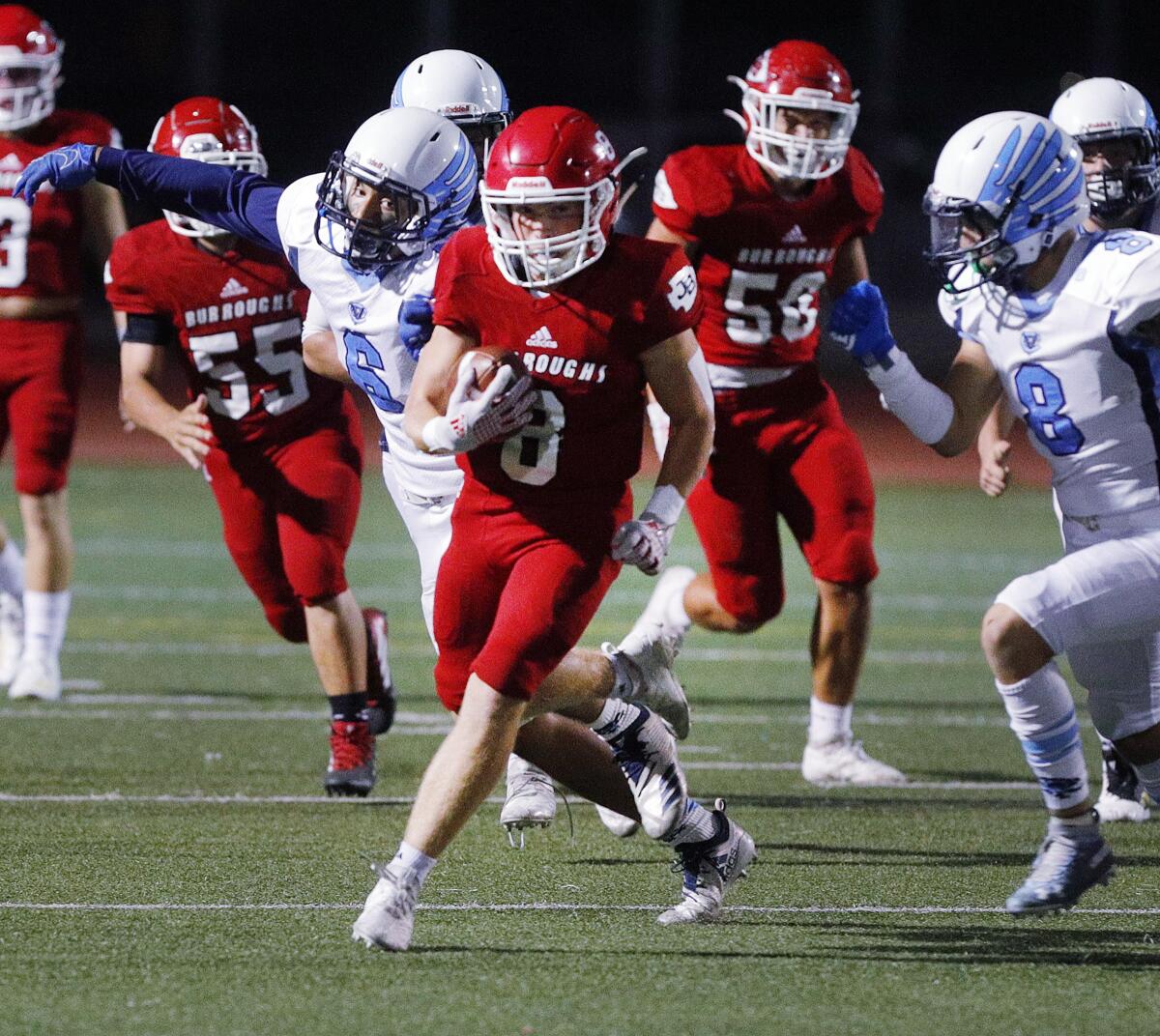 Burroughs' Jon English runs with the ball against Crescenta Valley in a Pacific League football game at Memorial Field in Burbank on Tuesday, September 27, 2019.