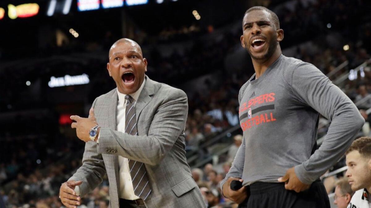 Clippers Coach Doc Rivers and guard Chris Paul argue a call with a referee during the second half of a game against the Spurs on Nov. 5.