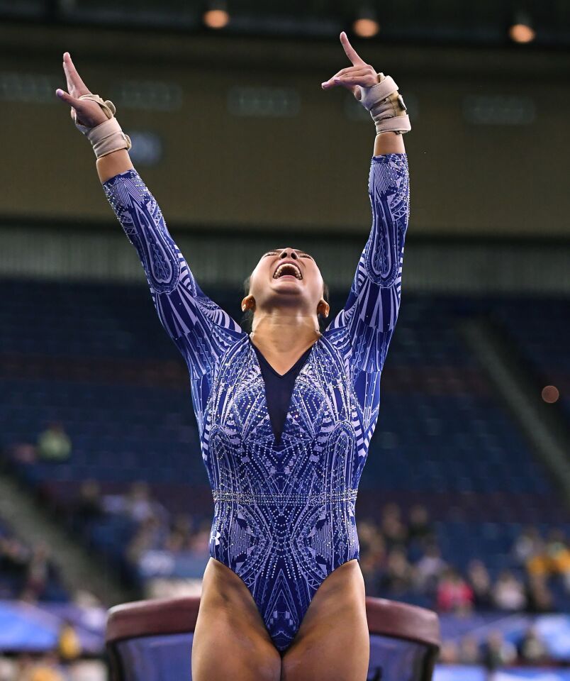 Kyla Ross exults after landing her vault during the semifinals of the NCAA Gymnastics Championship at the Ft. Worth Convention Center.