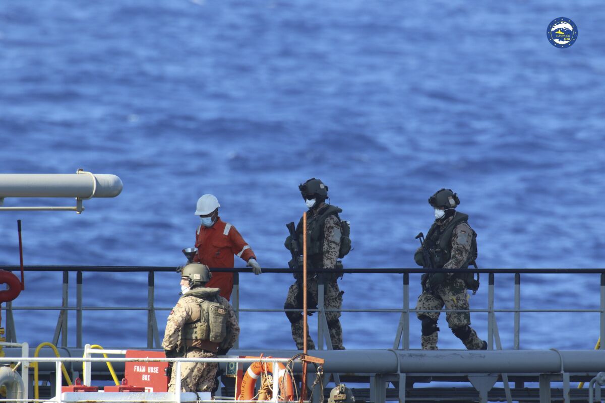 FILE - A boarding team inspects the Merchant Vessel Royal Diamond 7, in international waters, 150 kilometers north of the Libyan city of Derna, on Sept. 10, 2020, as the European Union maritime force enforced the U.N. arms embargo on Libya. The U.N. Security Council approved a resolution Friday, June 4, 2022, extending the authorization for countries and regional organizations to inspect vessels on the high seas off the coast of Libya suspected of violating the U.N. arms embargo on the troubled north African nation. (EUNAVFOR Med Irini/Italian Defense Ministry via AP, File)