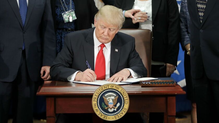 President Trump signs an executive order in January on border security and immigration enforcement.