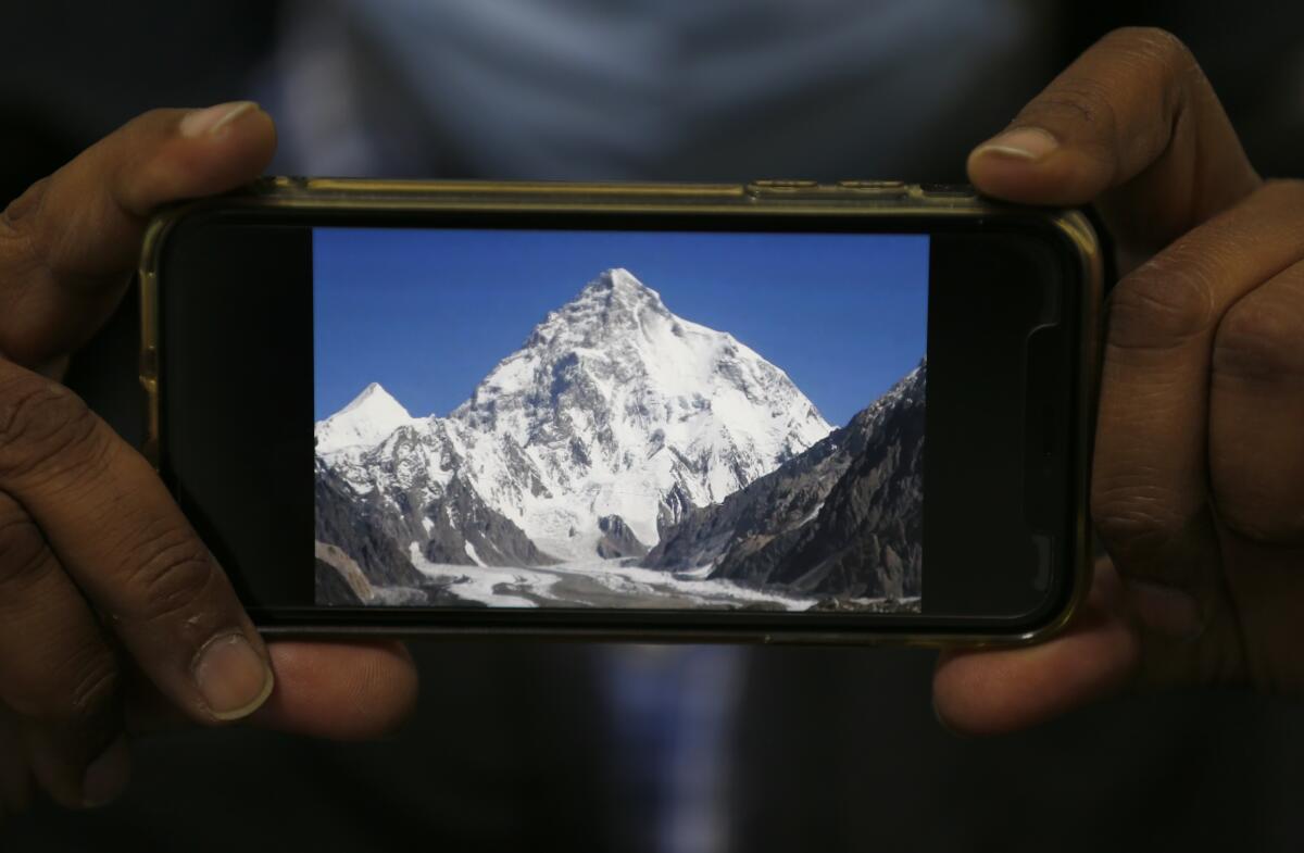 A cellphone photo of the snow-covered K2 mountain