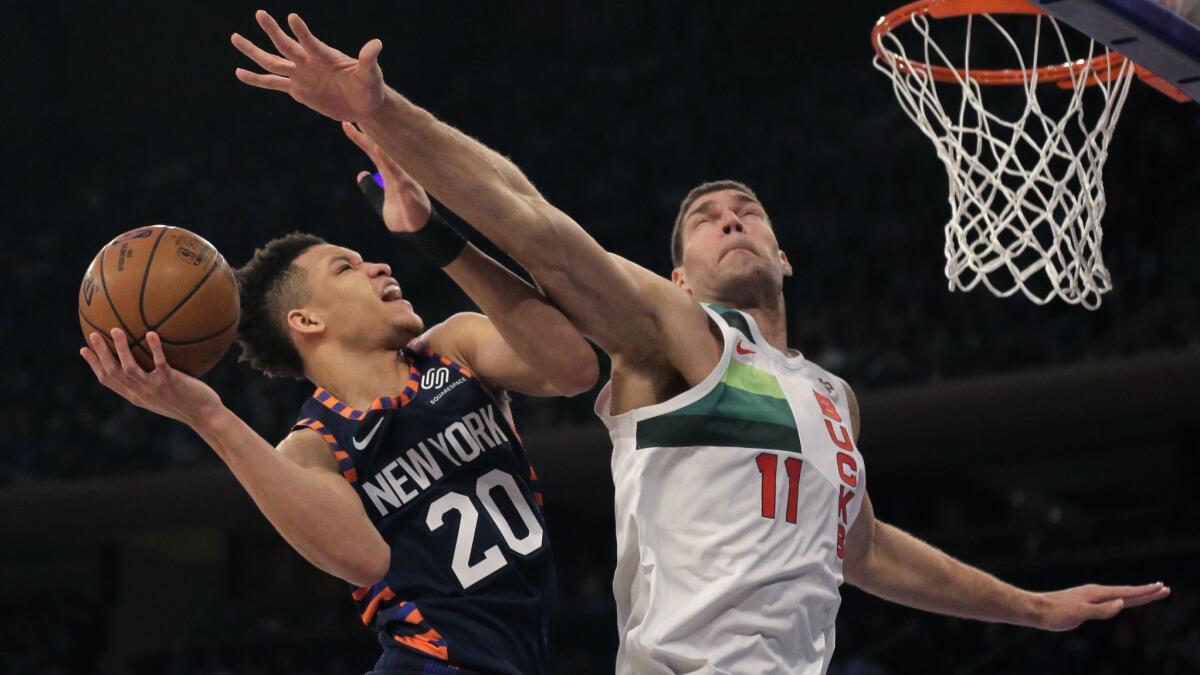 Knicks forward Kevin Knox has his layup challenged by Bucks center Brook Lopez during the first half Tuesday.