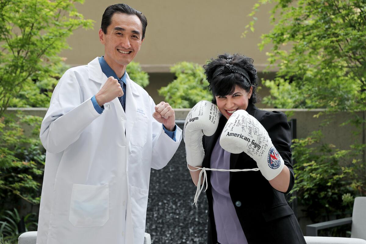 Newport Coast resident Laurie Paolone and her radiation oncologist, Dr. Brian Kim, at Hoag Hospital.