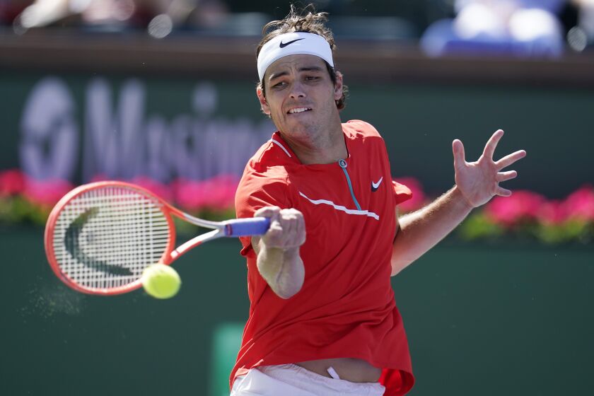 Taylor Fritz returns to Jaume Munar of Spain, at the BNP Paribas Open tennis tournament Tuesday, March 15, 2022, in Indian Wells, Calif. (AP Photo/Marcio Jose Sanchez)