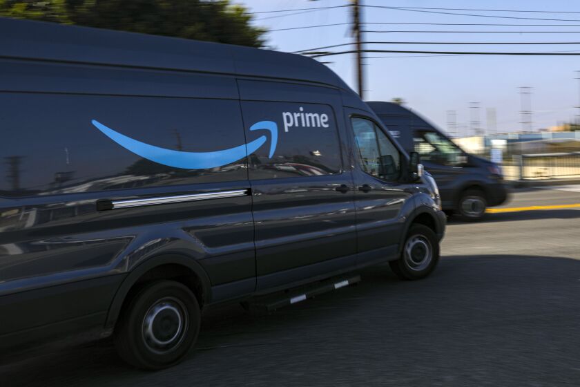 HAWTHORNE, CA - MAY 01: Delivery vans leave Amazon warehouse facility in Hawthorne. Hawthorne, CA. (Irfan Khan / Los Angeles Times)