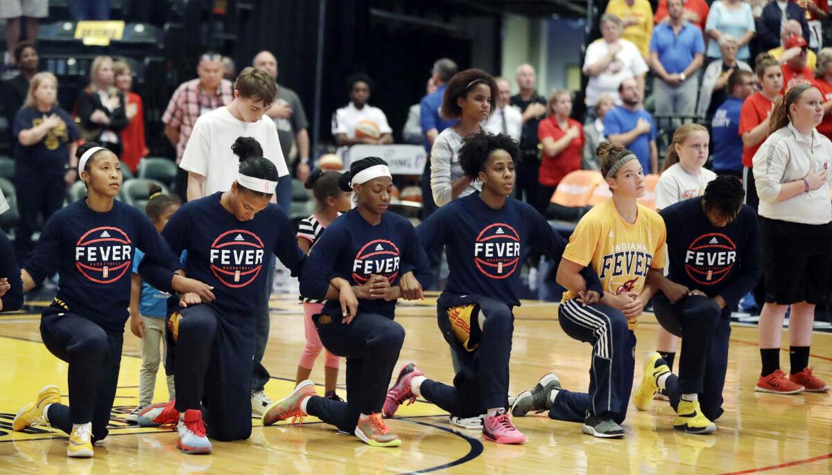 Members of the WNBA's Indiana Fever kneel during the national anthem on Wednesday.