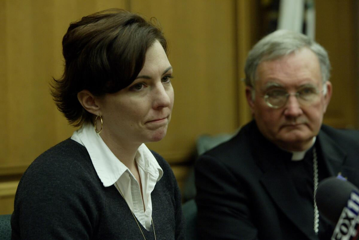 Sexual-abuse victim Joelle Casteix speaks out at the 2005 news conference as Bishop Tod Brown from the Orange Diocese looks on during the announcement of a settlement between the diocese and 87 alleged victims of childhood sexual abuse in the Catholic Church.