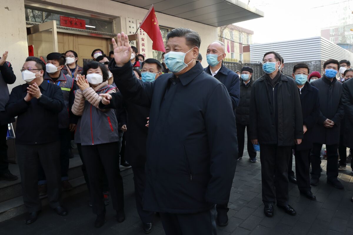 Chinese President Xi Jinping, center, visits a Beijing neighborhood