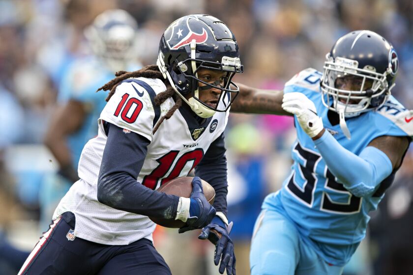 NASHVILLE, TN - DECEMBER 15: DeAnde Hopkins #10 of the Houston Texans runs the ball in the second half and is chased by Tramaine Brock Sr. #35 of the Tennessee Titans at Nissan Stadium on December 15, 2019 in Nashville, Tennessee. The Texans defeated the Titans 24-21. (Photo by Wesley Hitt/Getty Images)