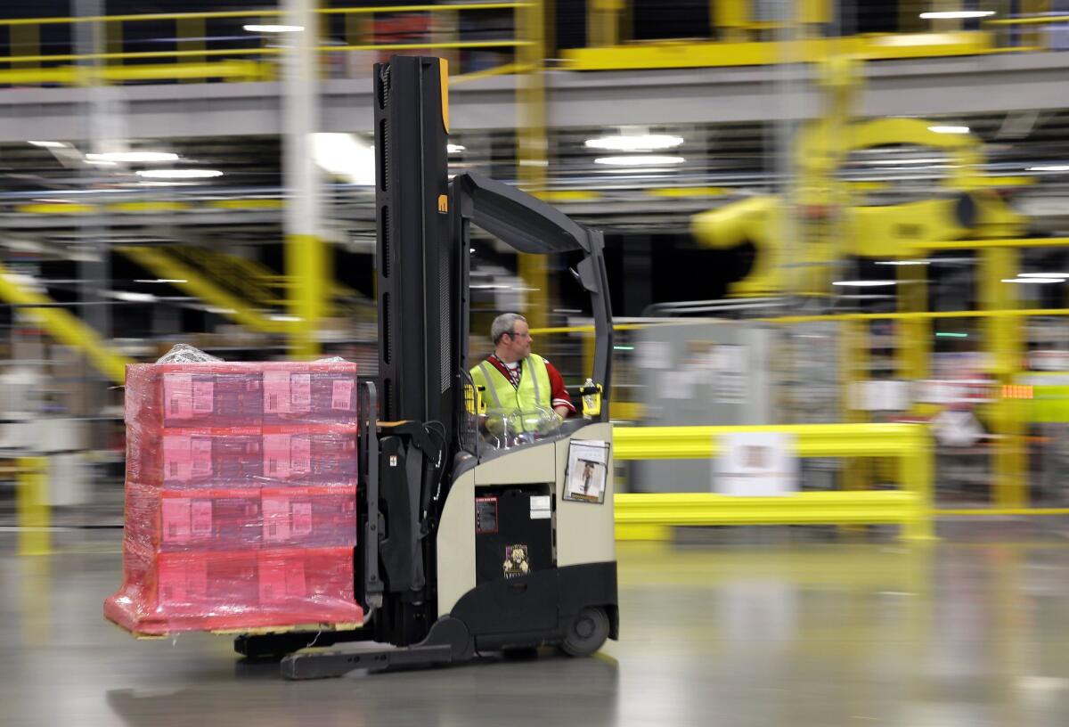 A forklift operator moves a pallet of goods at an Amazon.com fulfillment center in DuPont, Wash.