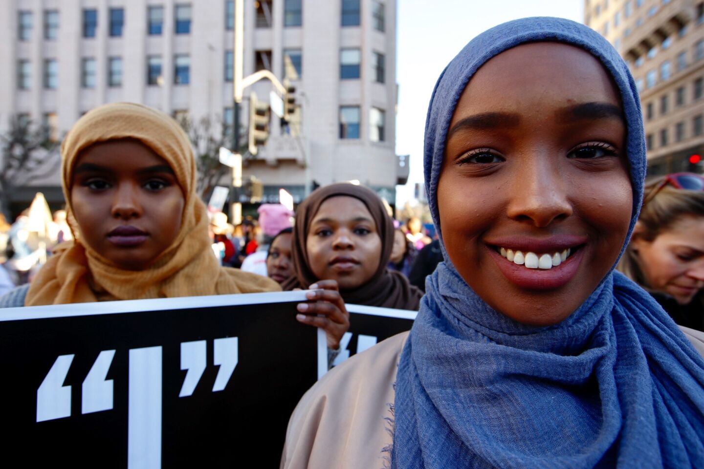 From left, Asha Isse, 19 Bilqis Kulungu, 19, and Safiya Hussein , 20, all of Los Angeles, arrive downtown to participate in the women's march.