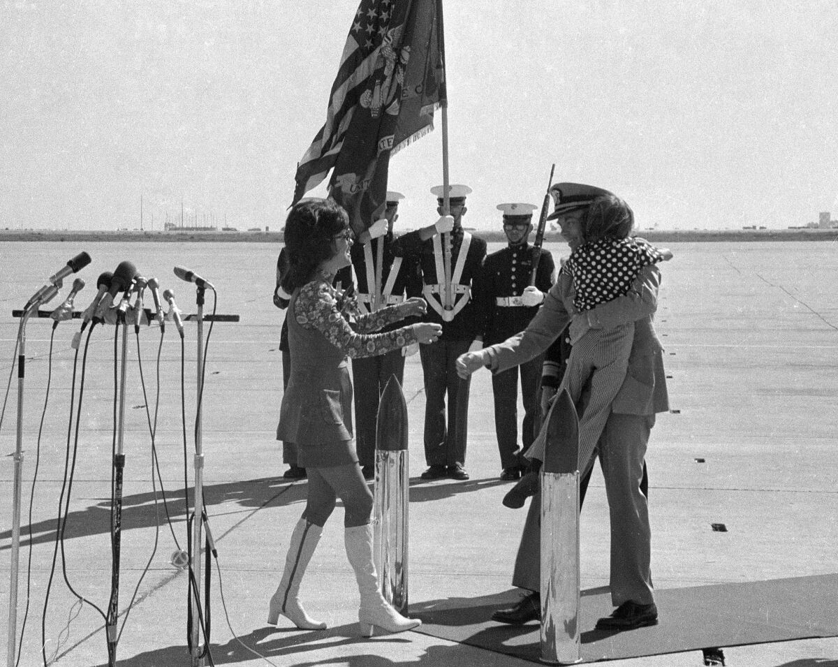 Cmdr. Robert Shumaker, a Vietnam POW for eight years, is greeted by his son, Grant, and wife, Lorraine at Miramar Naval Air Station on Feb. 15, 1973.