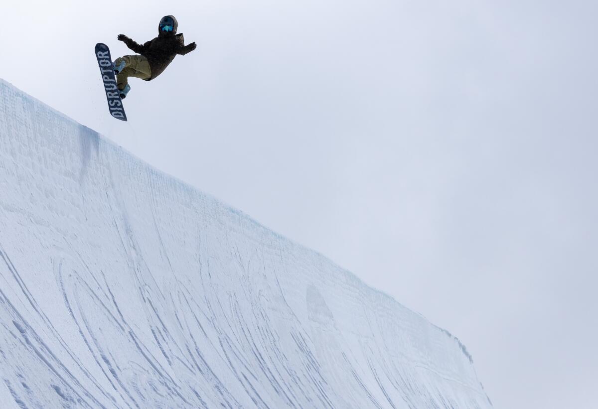 A snowboarder flies above the lip on the Olympic-sized, 22-foot-tall half pipe at Mammoth Mountain
