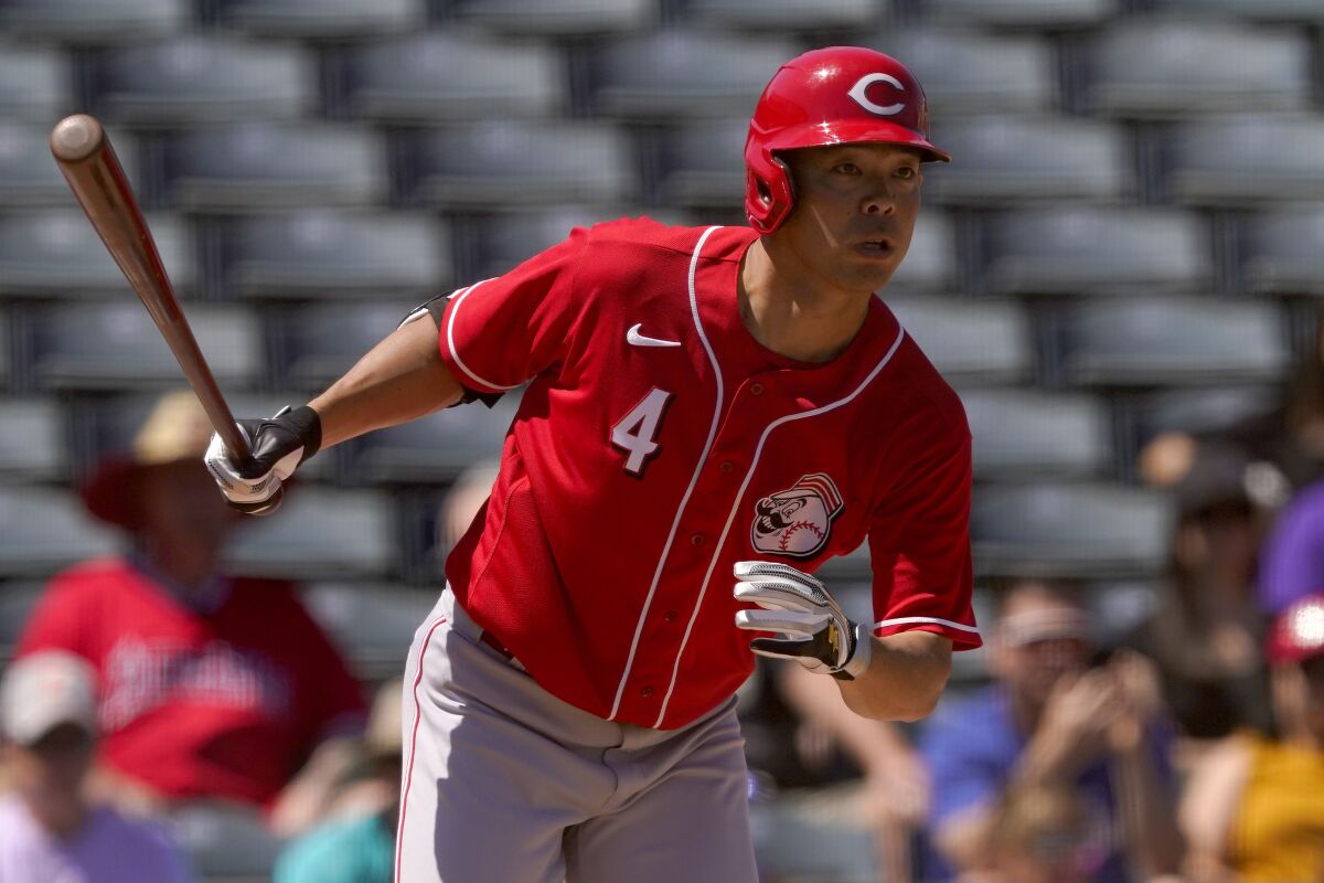 Cincinnati Reds' Shogo Akiyama (4) hits against the Los Angeles Angels during the first inning of a spring training baseball game, Friday, April 1, 2022, in Tempe, Ariz. (AP Photo/Matt York)