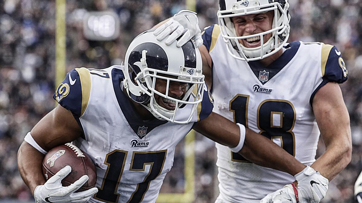 Rams receiver Robert Woods celebrates with teammate Cooper Kupp after scoring a touchdown in the third quarter Sunday.