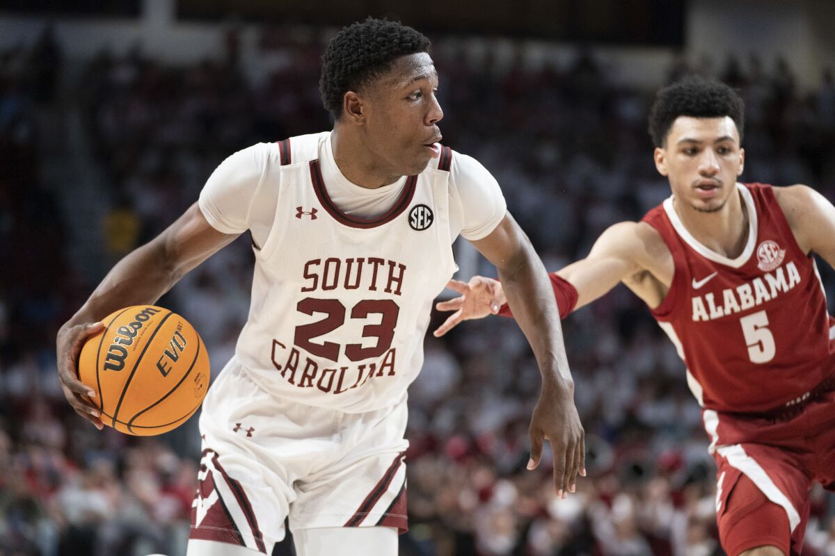 South Carolina forward Gregory Jackson II (23) is defended by Alabama guard Jahvon Quinerly (5) during the second half of an NCAA college basketball game Wednesday, Feb. 22, 2023, in Columbia, S.C. Alabama won 78-76 in overtime. (AP Photo/Sean Rayford)