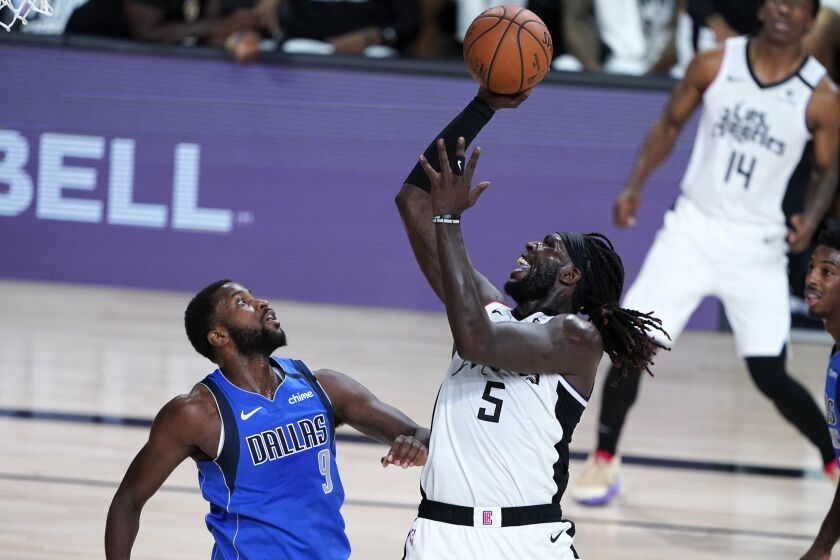 Los Angeles Clippers' Montrezl Harrell (5) shoots over Dallas Mavericks' Michael Kidd-Gilchrist (9) during the second half of an NBA basketball first round playoff game Tuesday, Aug. 25, 2020, in Lake Buena Vista, Fla. (AP Photo/Ashley Landis, Pool)