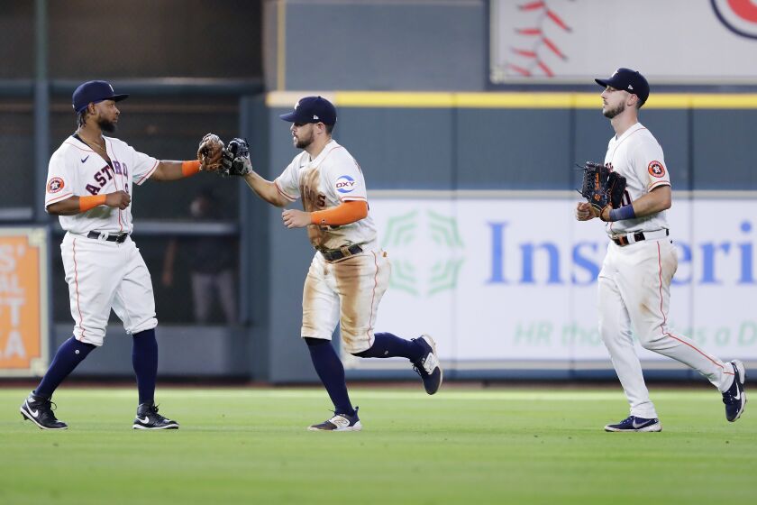 Houston Astros' outfielders, from left, Corey Julks, Chas McCormick and Kyle Tucker celebrate their 6-4 win over the Chicago White Sox after a baseball game Saturday, April 1, 2023, in Houston. (AP Photo/Michael Wyke)