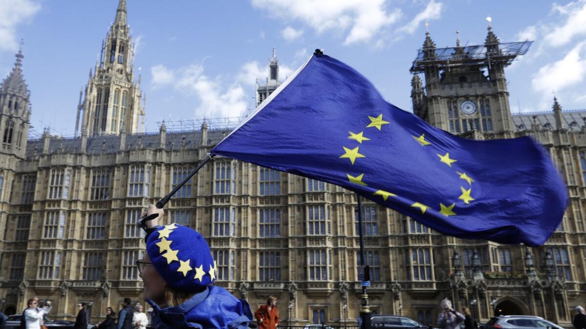 A woman waves a European Union flag in London on Monday.