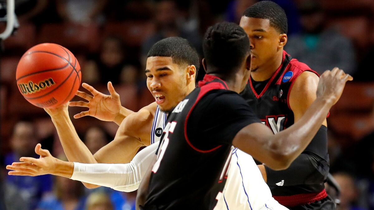 Duke forward Jayson Tatum makes a pass through the double-team defense of Troy during the first half.