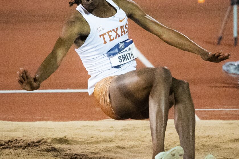 Texas' Ackelia Smith competes in the long jump finals at the NCAA outdoor track and field championships Thursday, June 8, 2023, in Austin, Texas. (Sara Diggins/Austin American-Statesman via AP)