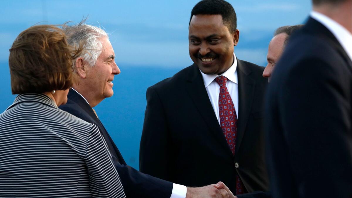 U.S. Secretary of State Rex Tillerson, left, is greeted by Ethiopia Minister of Foreign Affairs, Workneh Gebeyehu, right, and other officials, as he arrives to begin a six-day trip in Africa