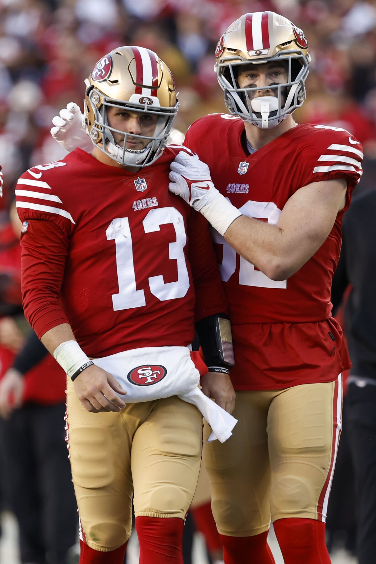 Tight end Ross Dwelley supports 49ers quarterback Brock Purdy (13) against Dallas.