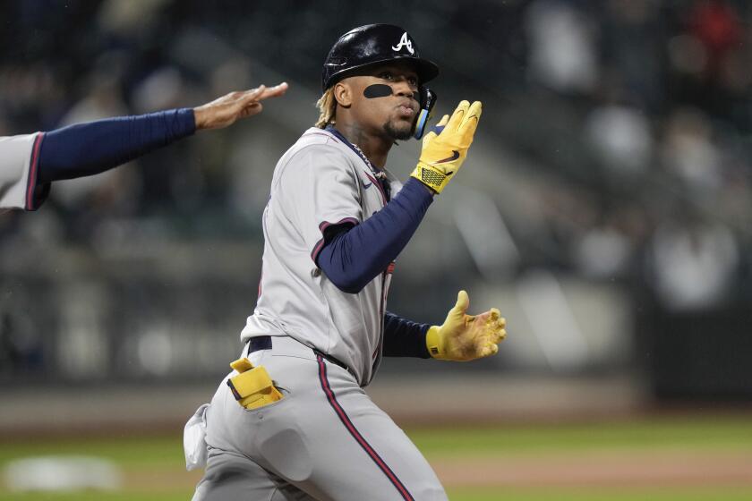 Atlanta Braves' Ronald Acuña Jr. gestures to fans as he runs the bases after hitting a home run against the New York Mets during the third inning of a baseball game Friday, May 10, 2024, in New York. (AP Photo/Frank Franklin II)
