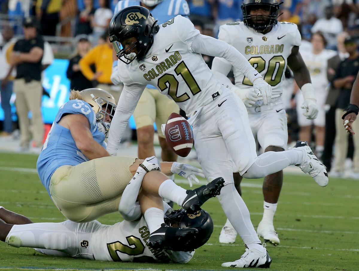UCLA running back Carson Steele fumbles after a big hit by Colorado safety Shilo Sanders at the Rose Bowl on Saturday.
