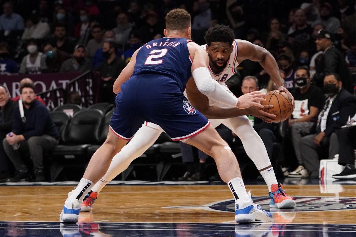 Brooklyn Nets forward Blake Griffin (2) guards against Philadelphia 76ers center Joel Embiid during the first half of an NBA basketball game, Thursday, Dec. 16, 2021, in New York. (AP Photo/Mary Altaffer)