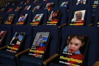 Some of the photographs of over one thousand persons killed, missing or abducted in the Hamas attack on Israel on Oct. 7 are displayed on empty seats in an exhibit held under the motto "UNITED AGAINST TERRORISM" in the Smolarz Auditorium at Tel Aviv University, Sunday Oct. 22, 2023, in Tel Aviv. (AP Photo/Ohad Zwigenberg)