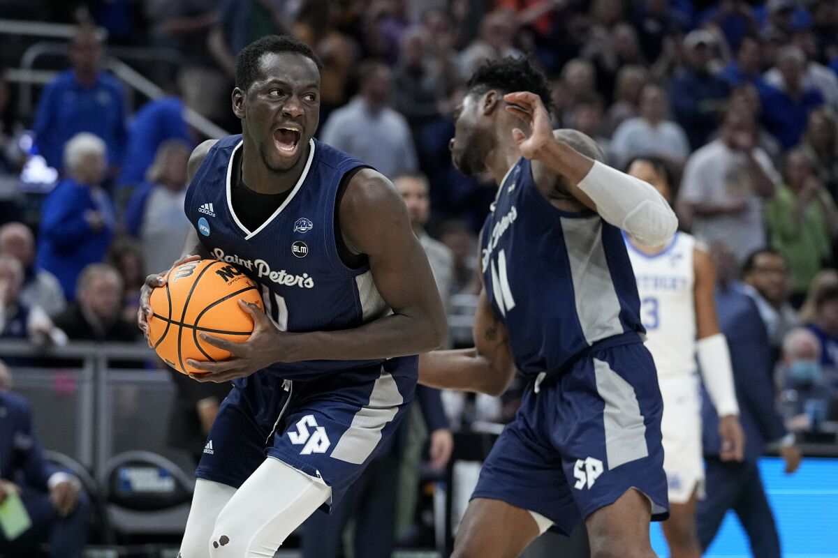 St. Peter's forward Hassan Drame celebrates after grabbing a rebound.