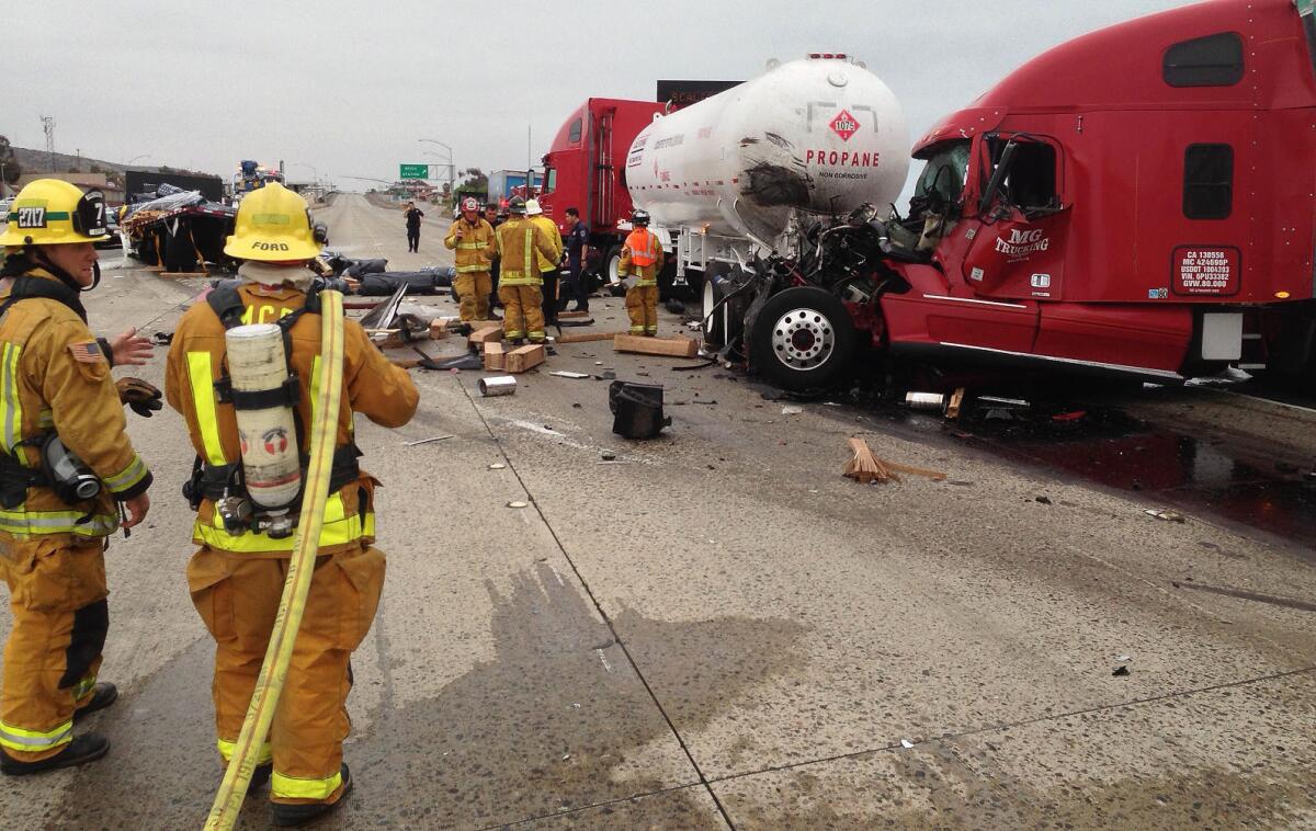 A collision between a flatbed truck and three big rigs two miles south of Basilone Road led to a fuel spill across all lanes of southbound Interstate 5 freeway south of San Clemente.