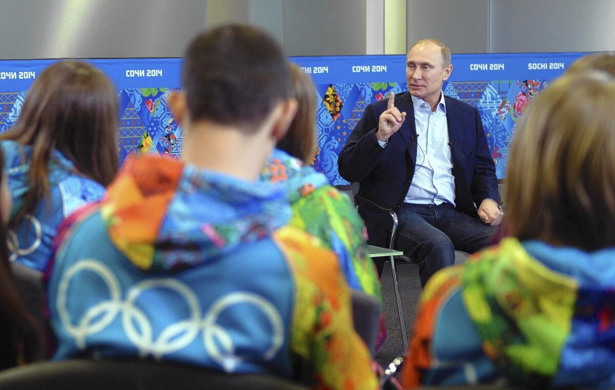 Russian President Vladimir Putin is seen on Jan. 17 meeting volunteers for the upcoming Winter Olympic Games in Sochi.