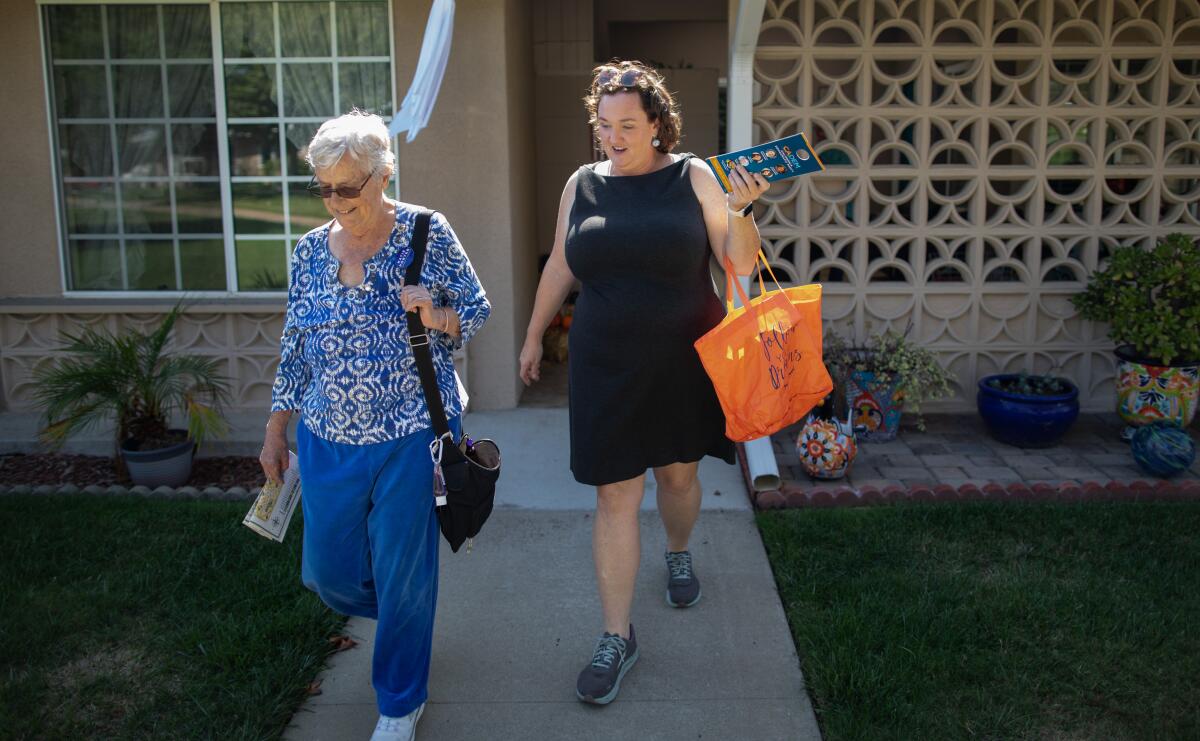 Rep. Katie Porter (D-Irvine), right, canvasses in a residential neighborhood.